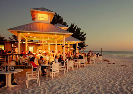 Walk hand in hand on the sugar sand beach at sunset